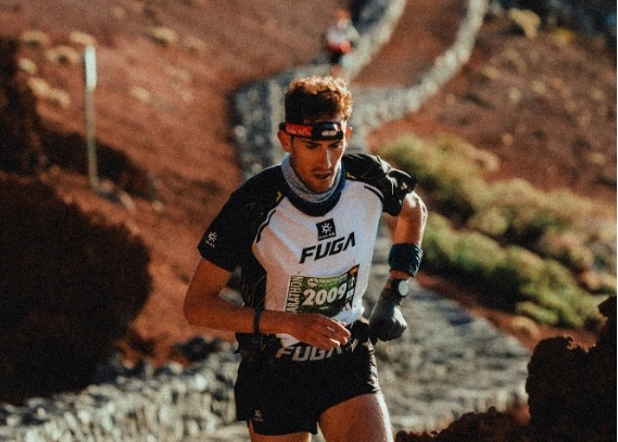 Runner Fran Anguita Bayo in Kailas FUGA gear powers up a rugged volcanic trail during TransVulcania Marathon, focused and determined.
