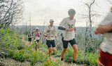 Group trail runners racing on mountain path